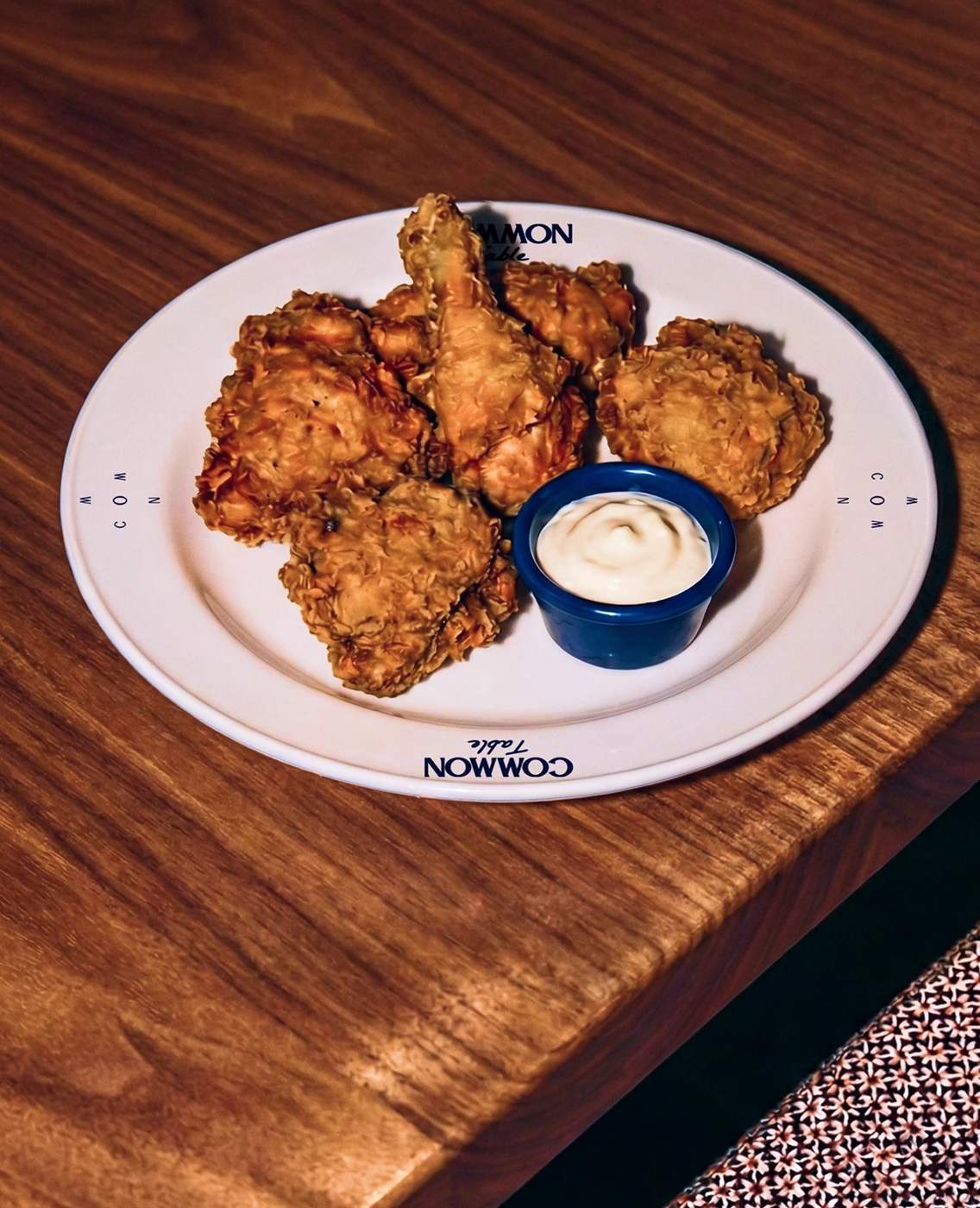 Common Table — 접시 테두리에 모노그램과 로고를 둘렀다