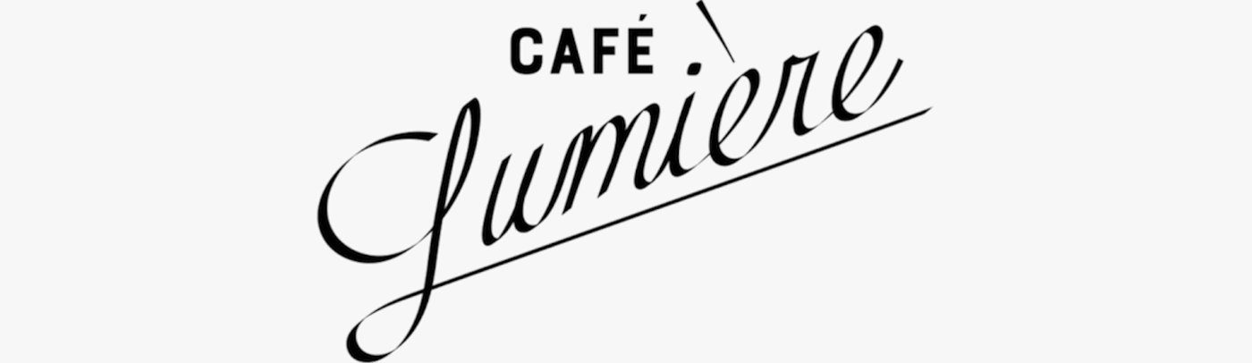 Café Lumière — CAFÉ 위에 비스듬히 흐르는 필기체 Lumière 로고
